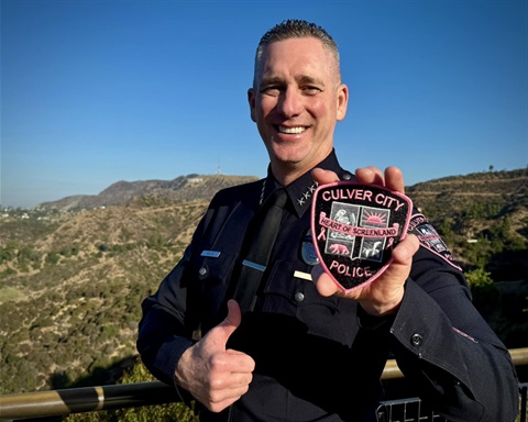 Chief Sims holding a pink patch