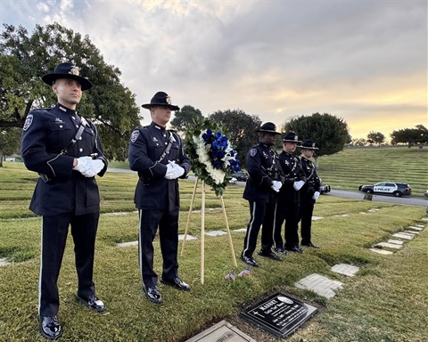 Culver City Police stand at attention beside the grave of Lieutenant Curtis 