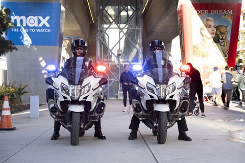 two police motor officers with red and blue lights flashing