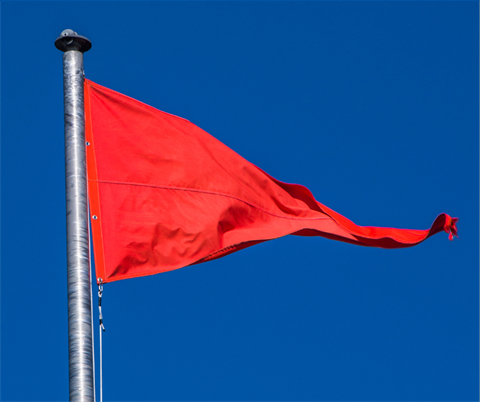 red flag waving in blue sky